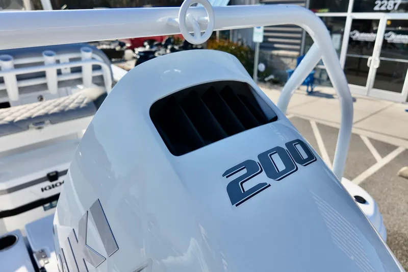 Slide: The Image of 2026 NauticStar 231 Hybrid boat with Suzuki 200 outboard engine, close-up view. - 19