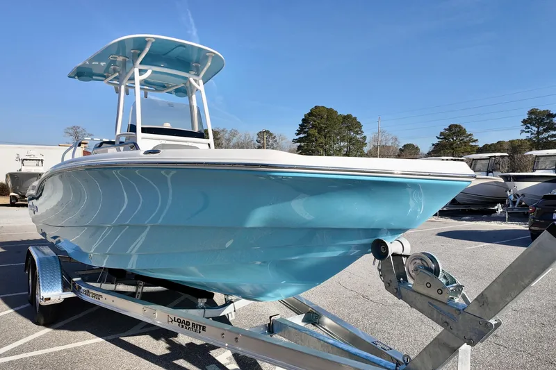 Slide: The Image of 2026 NauticStar 231 Hybrid boat on trailer, featuring sleek blue hull design. - 2