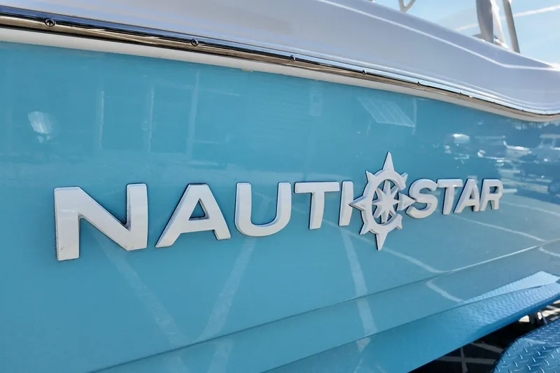 Slide: The Image of 2026 NauticStar 231 Hybrid boat logo on light blue hull. - 21