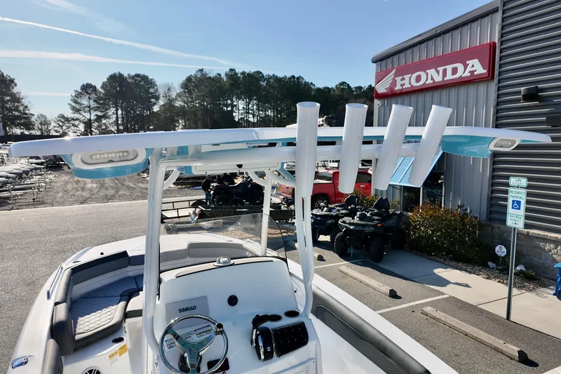 Slide: The Image of 2026 NauticStar 231 Hybrid boat at dealership, featuring sleek design and advanced controls. - 4