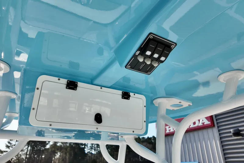 Slide: The Image of 2026 NauticStar 231 Hybrid boat interior with blue ceiling and control panel. - 5