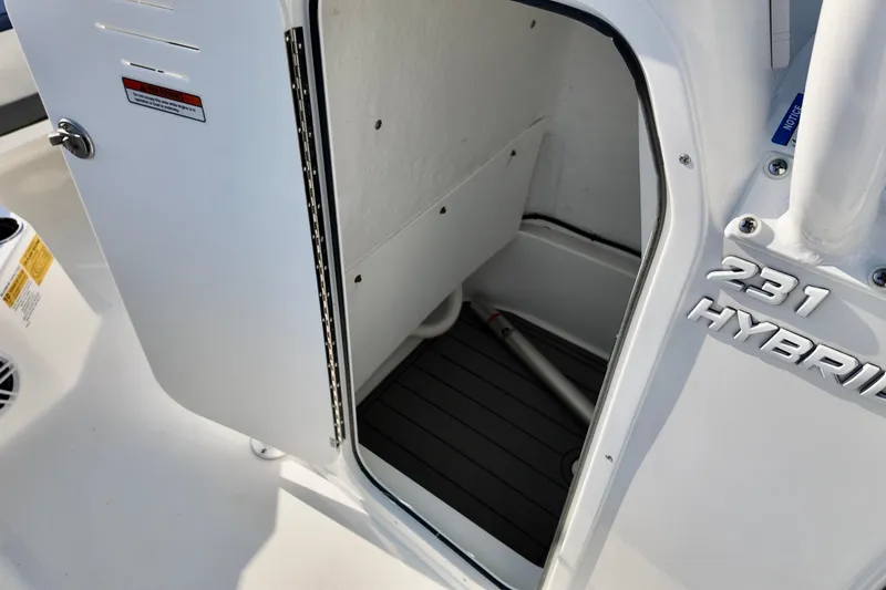 Slide: The Image of 2026 NauticStar 231 Hybrid boat interior with open storage compartment. - 7