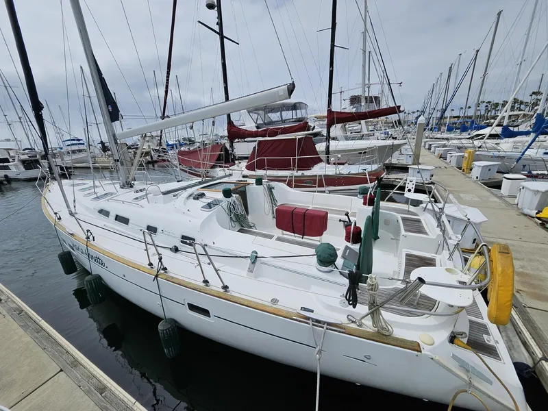 Slide: The Image of 2001 Beneteau Oceanis Clipper 473 sailboat docked at marina, featuring sleek design and spacious deck. - 1