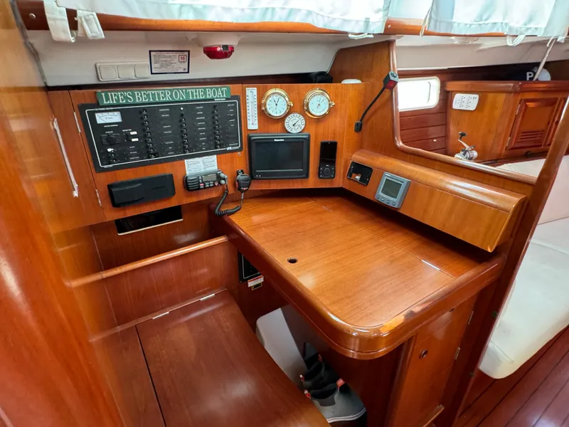 Slide: The Image of Navigation station of 2001 Beneteau Oceanis Clipper 473 with wood finish and control panels. - 16