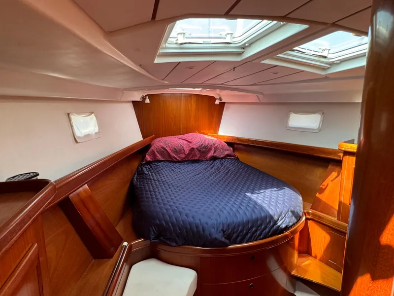 Slide: The Image of Cozy cabin interior of 2001 Beneteau Oceanis Clipper 473 sailboat with skylight and wooden finish. - 19