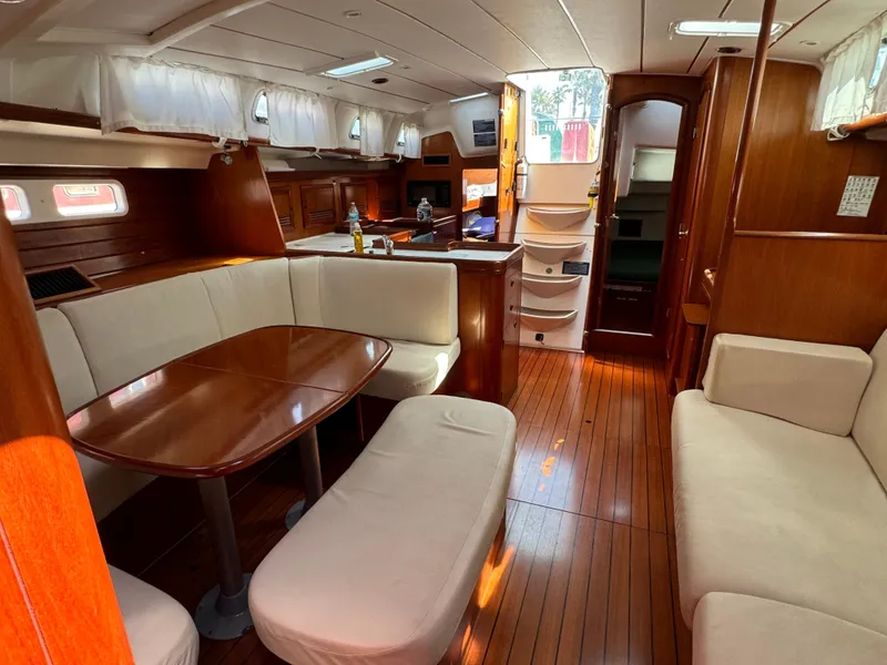 Slide: The Image of Interior of 2001 Beneteau Oceanis Clipper 473 yacht with wooden flooring and cozy seating. - 23