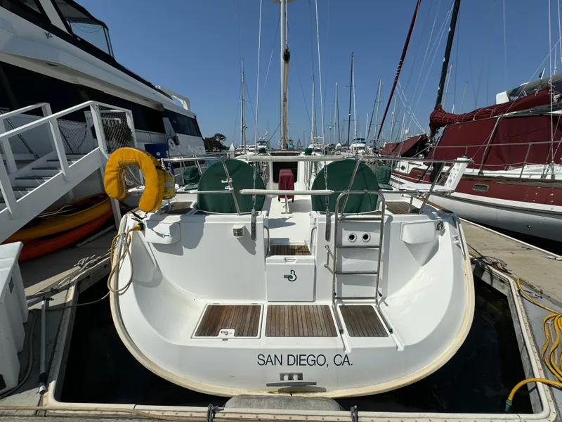 Slide: The Image of Beneteau Oceanis Clipper 473 sailboat docked in San Diego marina, rear view, sunny day. - 4