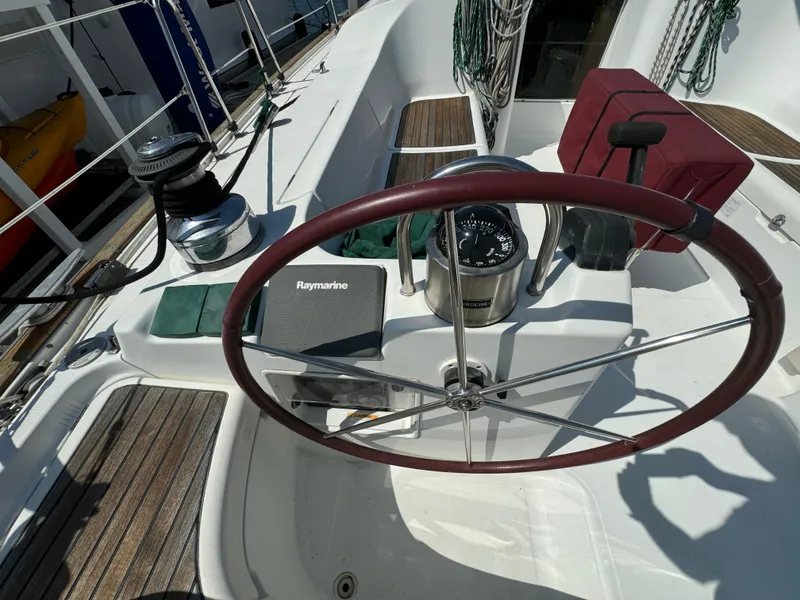 Slide: The Image of Cockpit of 2001 Beneteau Oceanis Clipper 473 sailboat with steering wheel and navigation equipment. - 5