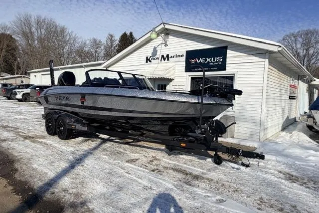 Slide: The Image of 2026 Vexus VXs20 boat on trailer outside dealership in snowy setting. - 6