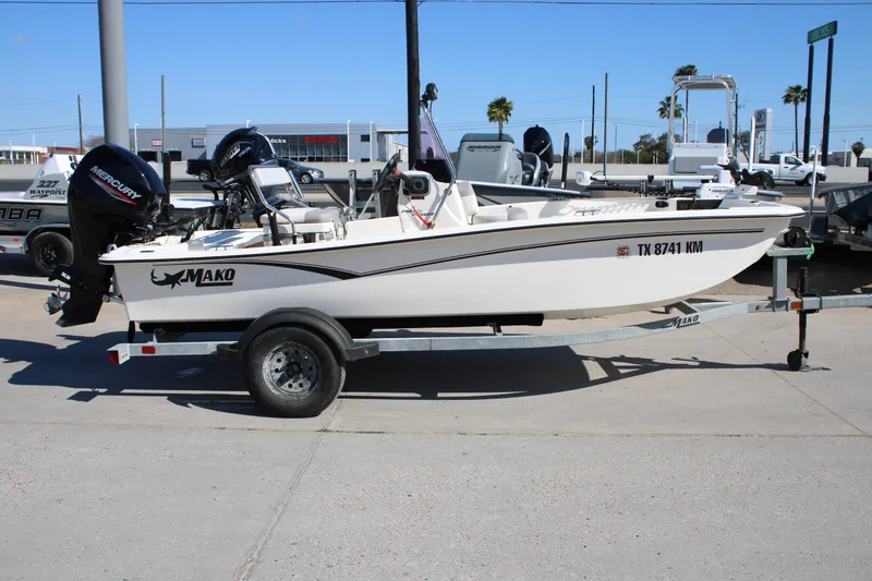 The Image of 2022 Mako Pro Skiff 15 CC boat on trailer, side view, outdoors. - 0