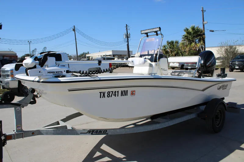 Slide: The Image of 2022 Mako Pro Skiff 15 CC boat on trailer, featuring Minn Kota motor. - 10