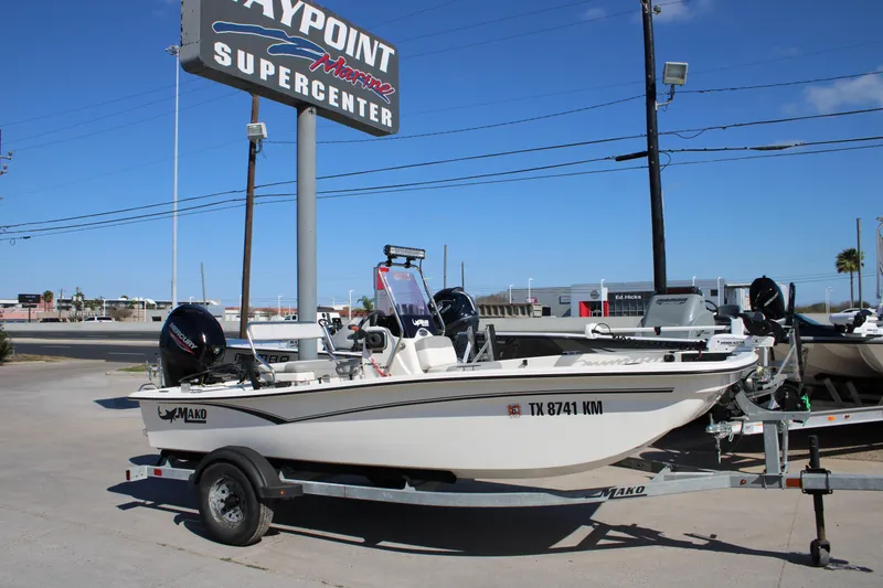 Slide: The Image of 2022 Mako Pro Skiff 15 CC boat on trailer at dealership under clear blue sky. - 8