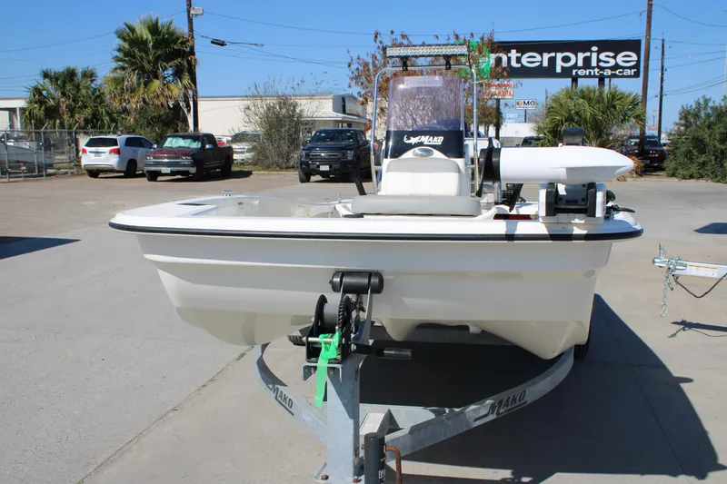 Slide: The Image of 2022 Mako Pro Skiff 15 CC boat on trailer in parking lot. - 9
