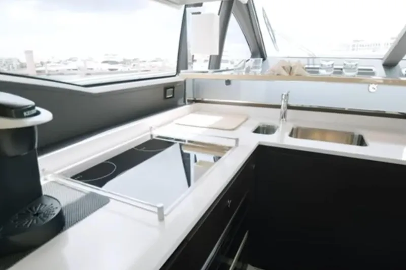 Slide: The Image of Modern kitchen interior on 2017 Azimut 66 yacht, featuring sleek countertops and appliances. - 11