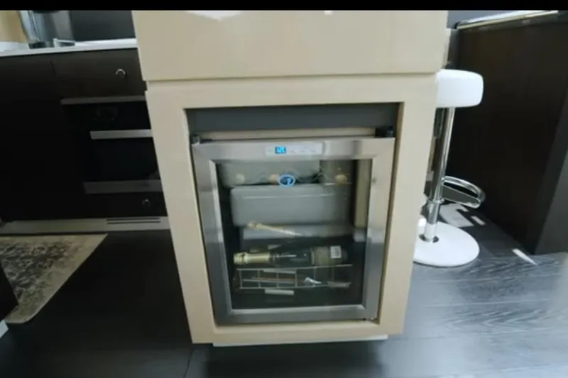 Slide: The Image of Mini fridge in 2017 Azimut 66 yacht interior, featuring a modern kitchen setup. - 12