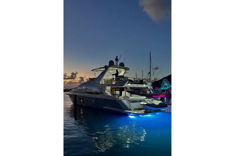 Slide: The Image of 2017 Azimut 66 yacht illuminated at sunset in a marina. - 2