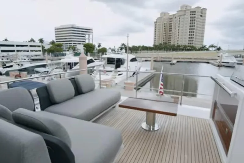 Slide: The Image of Luxurious 2017 Azimut 66 yacht with elegant deck seating at a marina. - 28