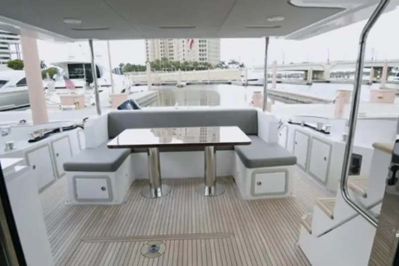 Slide: The Image of Luxurious 2017 Azimut 66 yacht deck with seating and table, docked at marina. - 3
