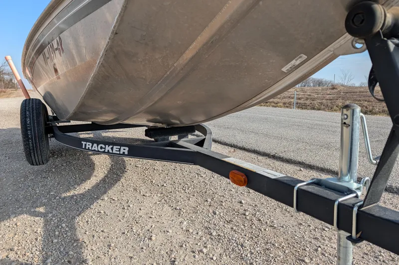 Slide: The Image of 2017 Tracker Panfish 16 boat on trailer, parked on gravel road. - 13