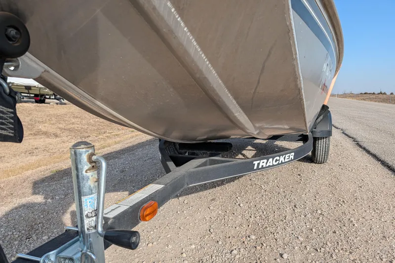 Slide: The Image of 2017 Tracker Panfish 16 boat on trailer, parked on a gravel road. - 14