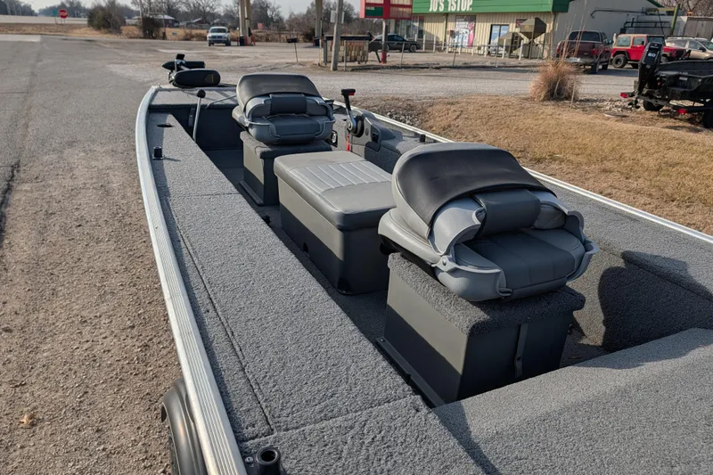 Slide: The Image of 2017 Tracker Panfish 16 boat with gray seating and carpeted interior. - 17