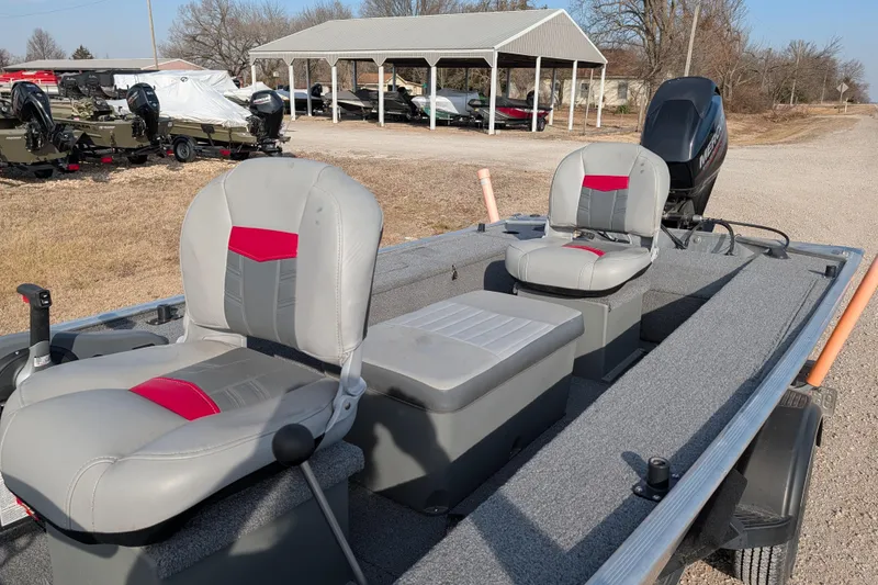 Slide: The Image of 2017 Tracker Panfish 16 boat with dual seats and outboard motor in a rural setting. - 18