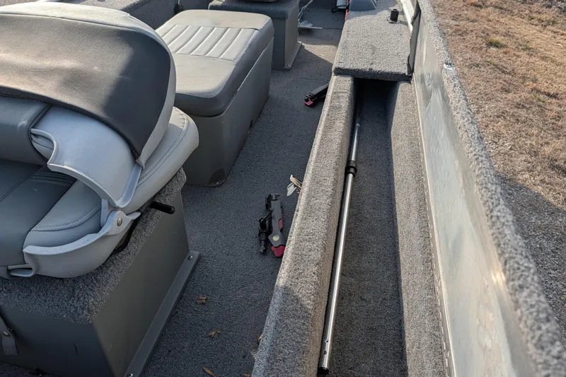 Slide: The Image of 2017 Tracker Panfish 16 boat interior with seating and storage compartments. - 24