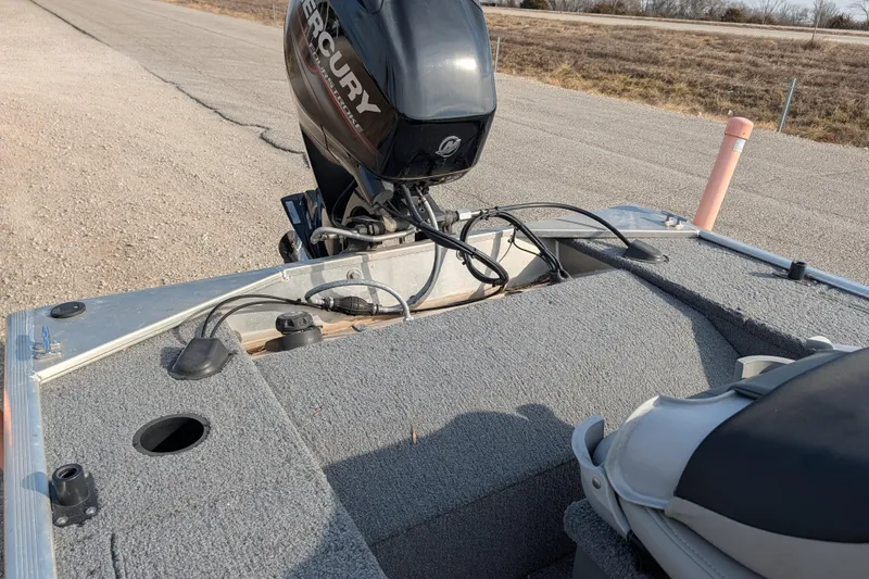 Slide: The Image of 2017 Tracker Panfish 16 boat with Mercury outboard motor on a paved road. - 25