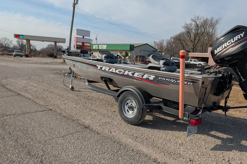Slide: The Image of 2017 Tracker Panfish 16 boat with Mercury engine parked near a gas station. - 6