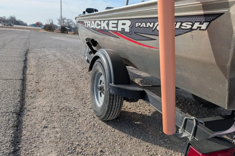 Slide: The Image of 2017 Tracker Panfish 16 boat on trailer, parked on gravel roadside. - 7