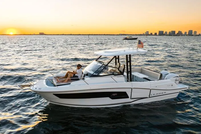 Slide: The Image of Manufacturer Provided Image: 2026 Jeanneau Leader 9.0 WA Series 2 boat cruising at sunset near city skyline. - 1