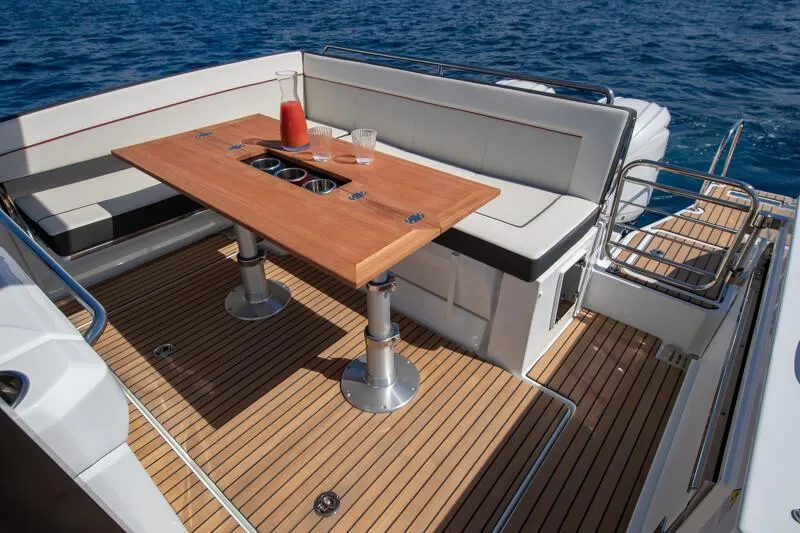 Slide: The Image of Manufacturer Provided Image: 2026 Jeanneau Leader 9.0 WA Series 2 boat deck with seating and wooden table. - 16