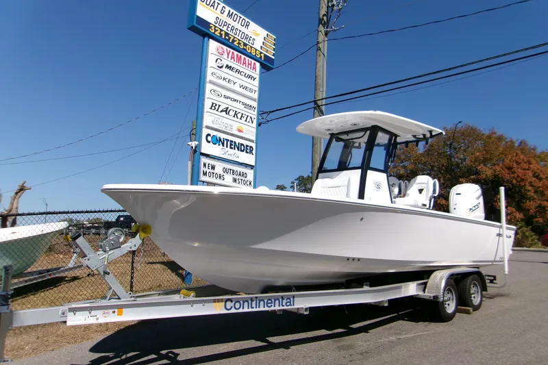 The Image of 2026 Sportsman Masters 267OE Bay Boat on trailer at dealership under clear blue sky. - 0