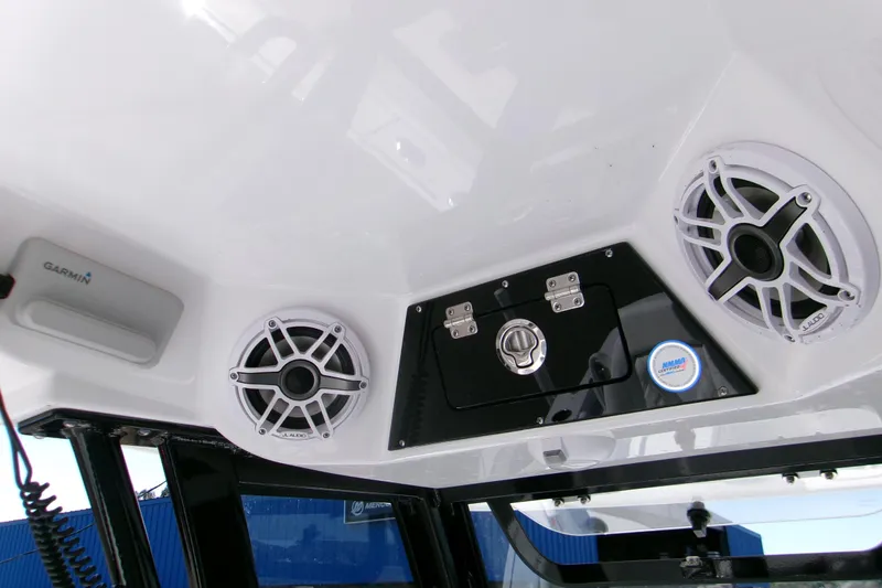 Slide: The Image of 2026 Sportsman Masters 267OE Bay Boat console with speakers and Garmin device. - 11