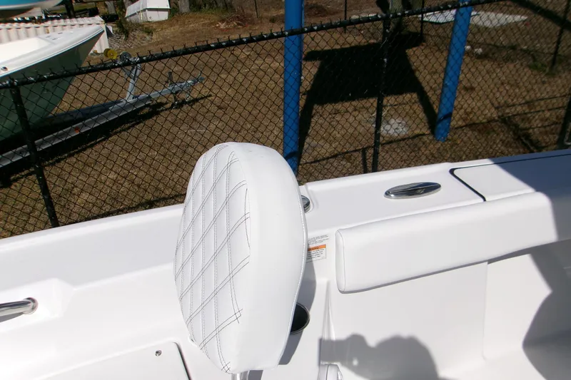 Slide: The Image of 2026 Sportsman Masters 267OE Bay Boat interior with white cushioned seating. - 13