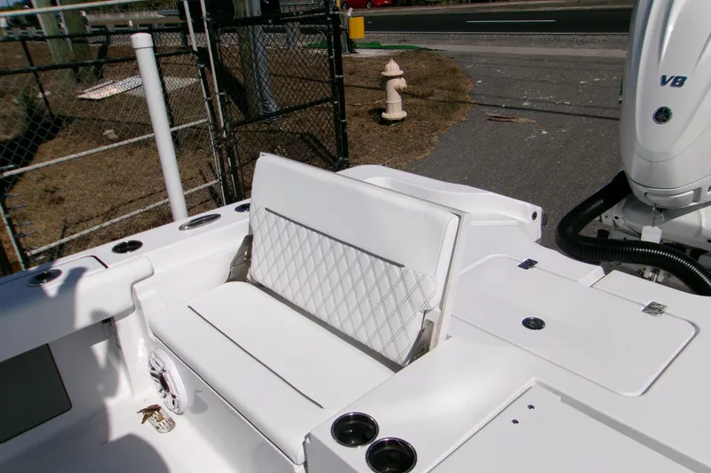 Slide: The Image of 2026 Sportsman Masters 267OE Bay Boat with white seating and V8 engine. - 18