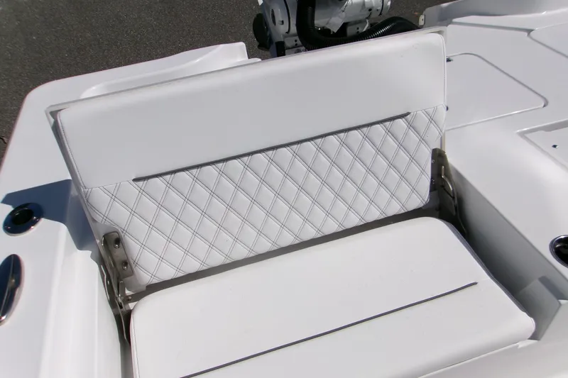 Slide: The Image of 2026 Sportsman Masters 267OE Bay Boat with white diamond-stitched seating detail. - 8
