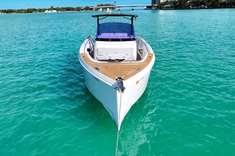 Slide: The Image of 2018 Fjord 36 Xpress boat anchored in turquoise waters, showcasing sleek design. - 1