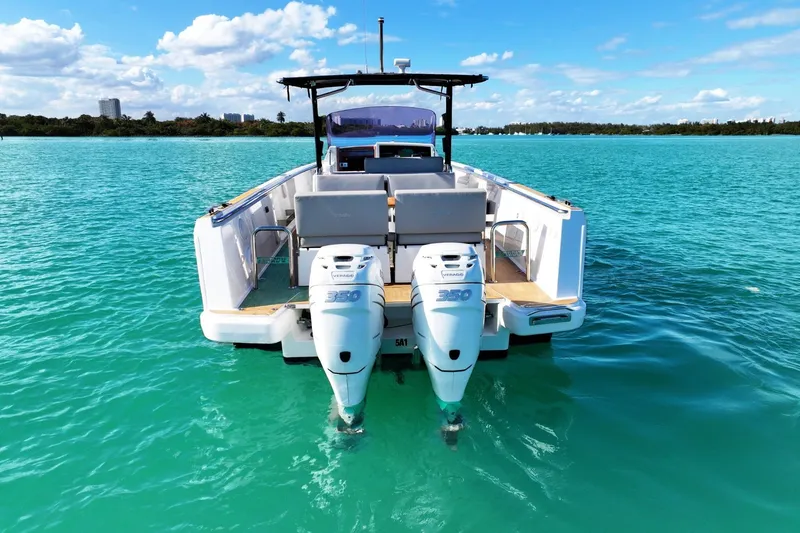 Slide: The Image of 2018 Fjord 36 Xpress boat with twin engines on turquoise water, clear sky background. - 11