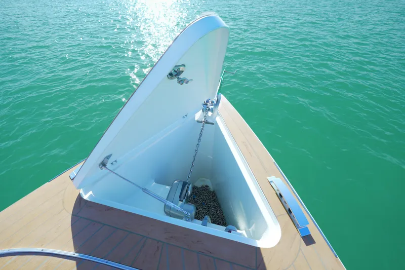 Slide: The Image of Open anchor compartment on 2018 Fjord 36 Xpress boat, floating on turquoise water. - 14