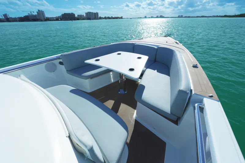 Slide: The Image of Luxurious 2018 Fjord 36 Xpress boat interior with seating and table on calm water. - 16