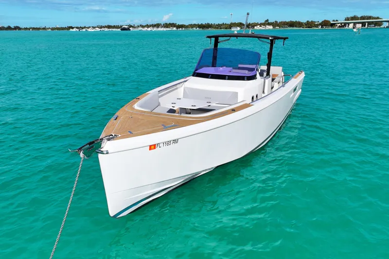 Slide: The Image of 2018 Fjord 36 Xpress boat anchored in turquoise waters. - 2