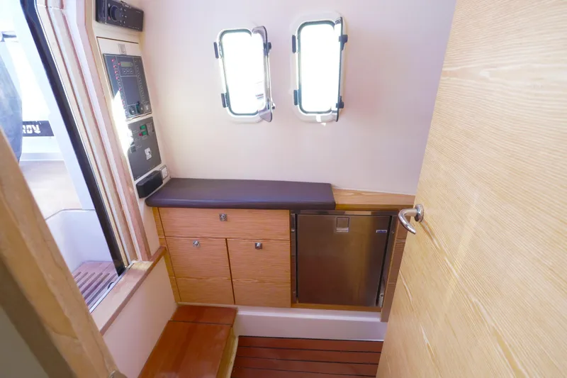 Slide: The Image of Interior of 2018 Fjord 36 Xpress yacht with wooden cabinetry and small window. - 21