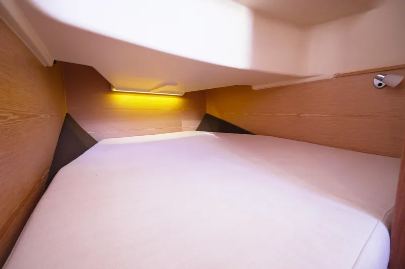 Slide: The Image of 2018 Fjord 36 Xpress cabin interior with cozy bed and ambient lighting. - 24