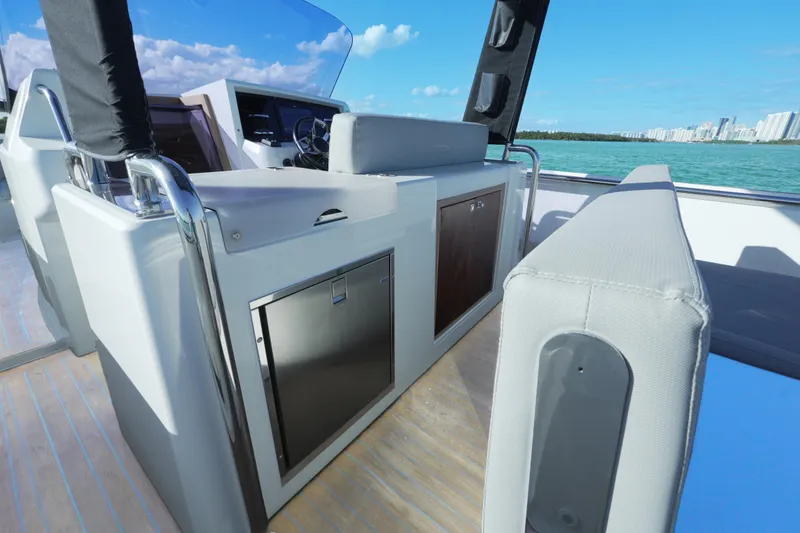 Slide: The Image of 2018 Fjord 36 Xpress boat interior with modern helm and seating, overlooking blue waters. - 29