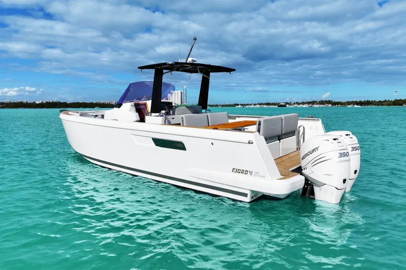 Slide: The Image of 2018 Fjord 36 Xpress boat on turquoise water with twin Mercury 350 engines. - 3