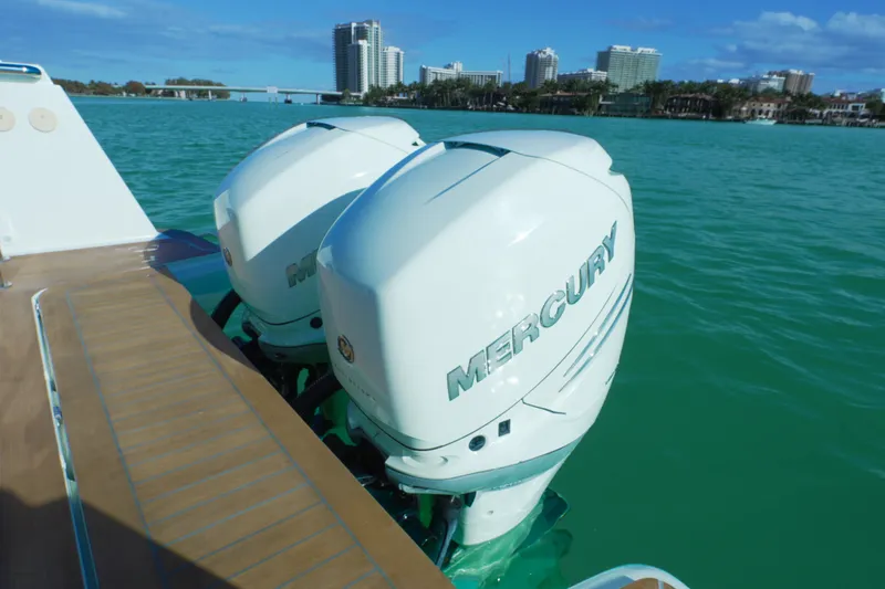 Slide: The Image of Twin Mercury outboard engines on a 2018 Fjord 36 Xpress, with city skyline in background. - 34