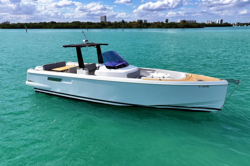 Slide: The Image of 2018 Fjord 36 Xpress boat on turquoise water under a partly cloudy sky. - 5