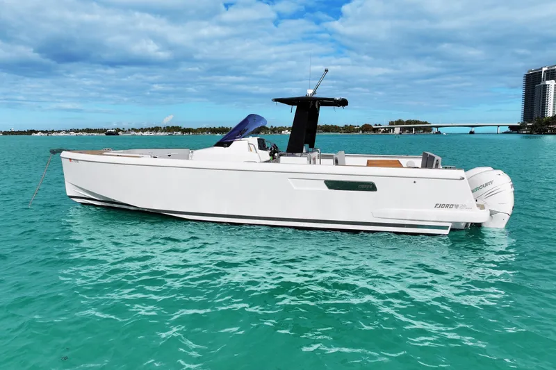 Slide: The Image of 2018 Fjord 36 Xpress boat on turquoise water, clear sky background. - 6