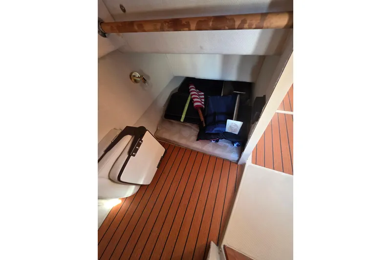 Slide: The Image of 2017 Ranger Tugs R-27 interior with wood flooring and storage area. - 16